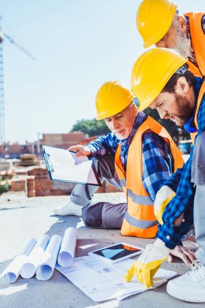 stock-photo-construction-workers-looking-at-building